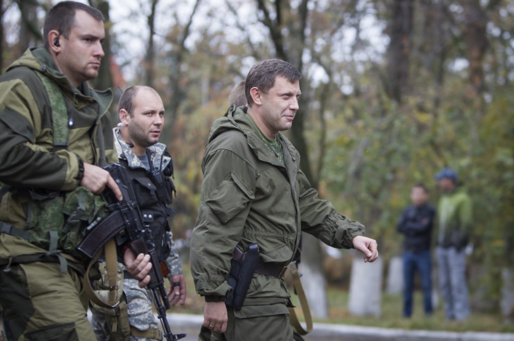 Prime Minister of the self-proclaimed Donetsk People's Republic Alexander Zakharchenko (C) walks to meet local residents during his election campaign tour to the southern coastal town of Novoazovsk, October 18, 2014. REUTERS/Shamil Zhumatov (UKRAINE - Tags: POLITICS CIVIL UNREST CONFLICT)