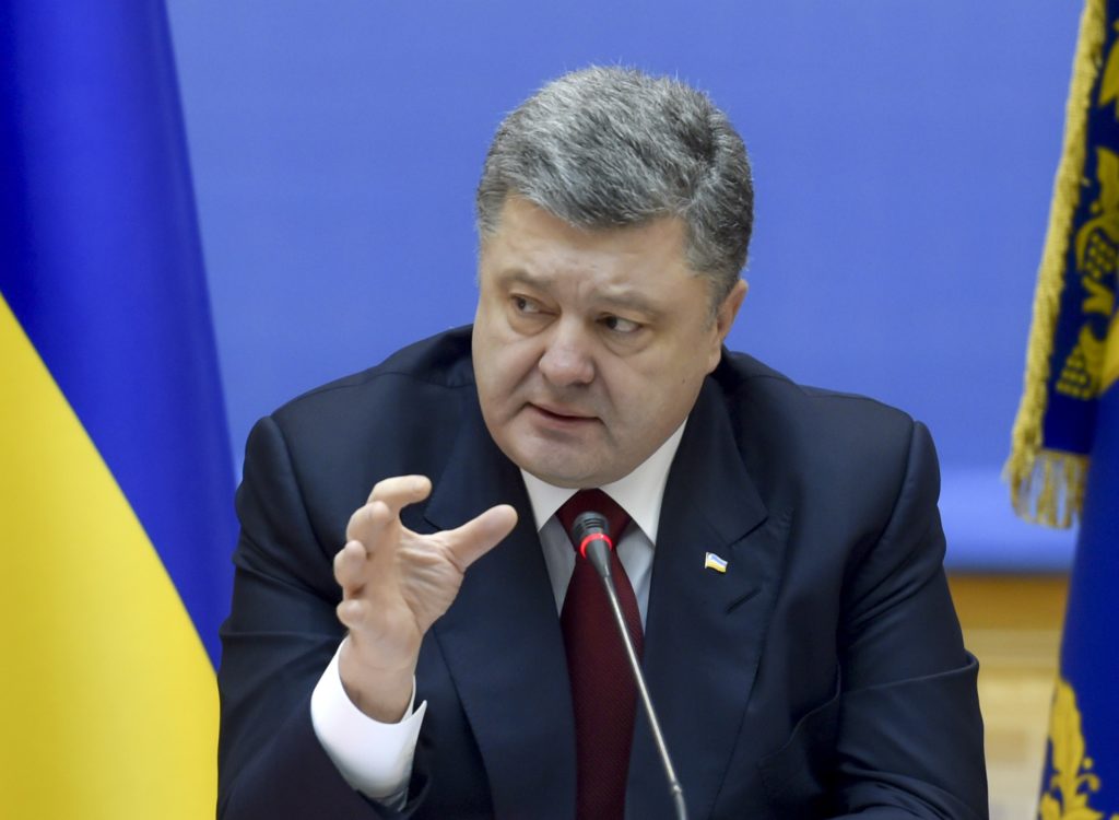 Ukrainian President Petro Poroshenko speaks during a government meeting in Kiev, February 11, 2015. Poroshenko said on Wednesday Ukraine was prepared to introduce martial law across Ukraine if the separatist conflict in the east escalates further, news agency Interfax reported. REUTERS/Mykola Lazarenko/Ukrainian Presidential Press Service/Handout via Reuters (UKRAINE - Tags: POLITICS CIVIL UNREST MILITARY CONFLICT) ATTENTION EDITORS - THIS PICTURE WAS PROVIDED BY A THIRD PARTY. REUTERS IS UNABLE TO INDEPENDENTLY VERIFY THE AUTHENTICITY, CONTENT, LOCATION OR DATE OF THIS IMAGE. FOR EDITORIAL USE ONLY. NOT FOR SALE FOR MARKETING OR ADVERTISING CAMPAIGNS. THIS PICTURE IS DISTRIBUTED EXACTLY AS RECEIVED BY REUTERS, AS A SERVICE TO CLIENTS